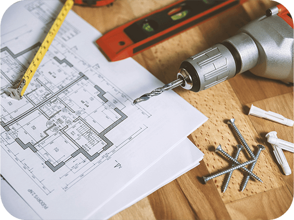 a table with blueprints and construction tools on it