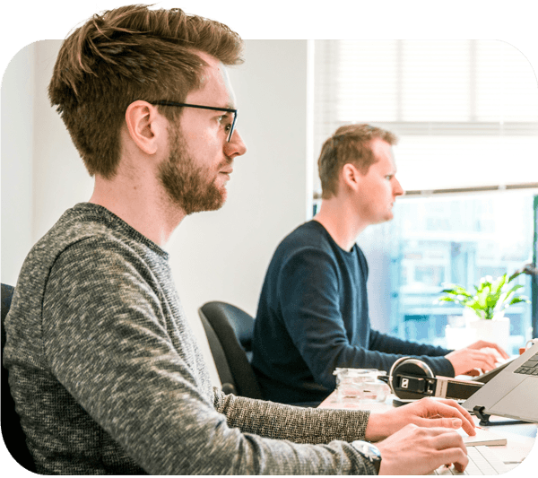 two men sitting at computers working